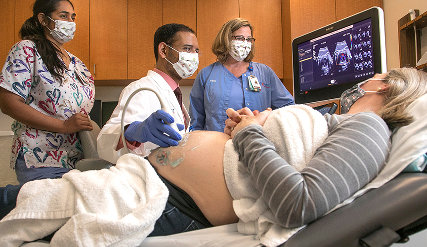 Fetal Cardiology team looking at ultra sound with mom